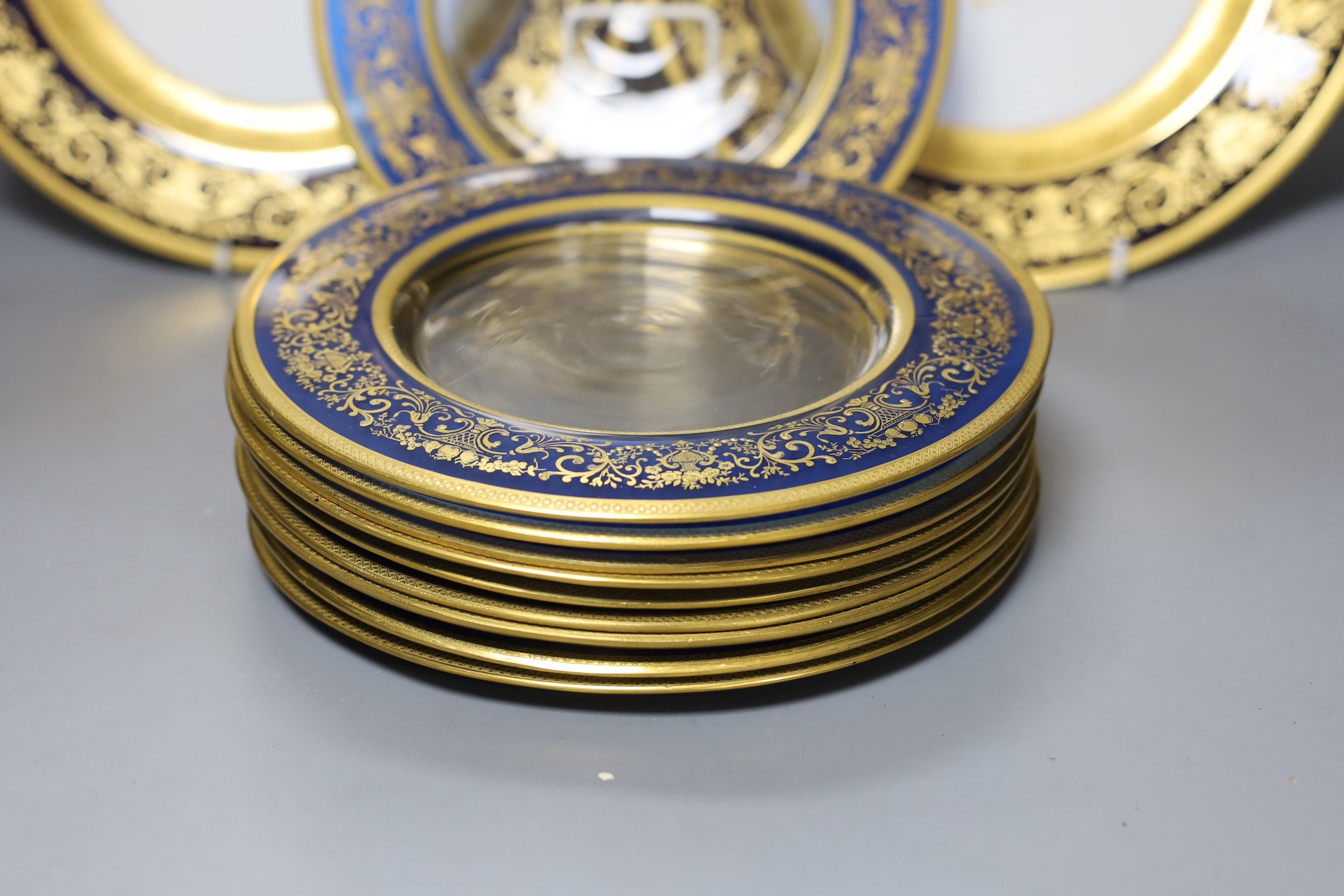 A set of 12 Hutschenreuther cabinet plates and a set of 10 gilded glass plates